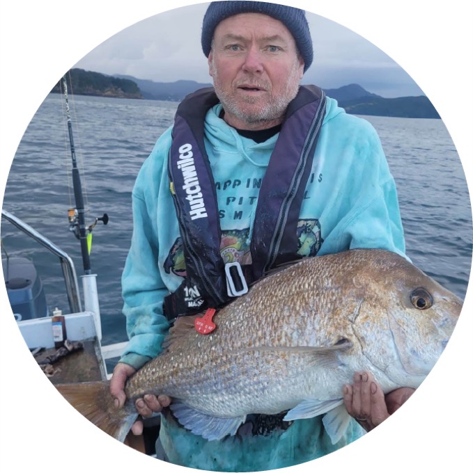 Baz holding a freshly caught snapper on the boat